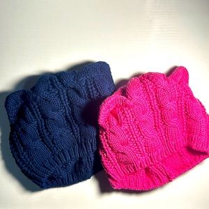 Kids cable knit winter hats one navy, one pink. One size fits ages 2 to 8.